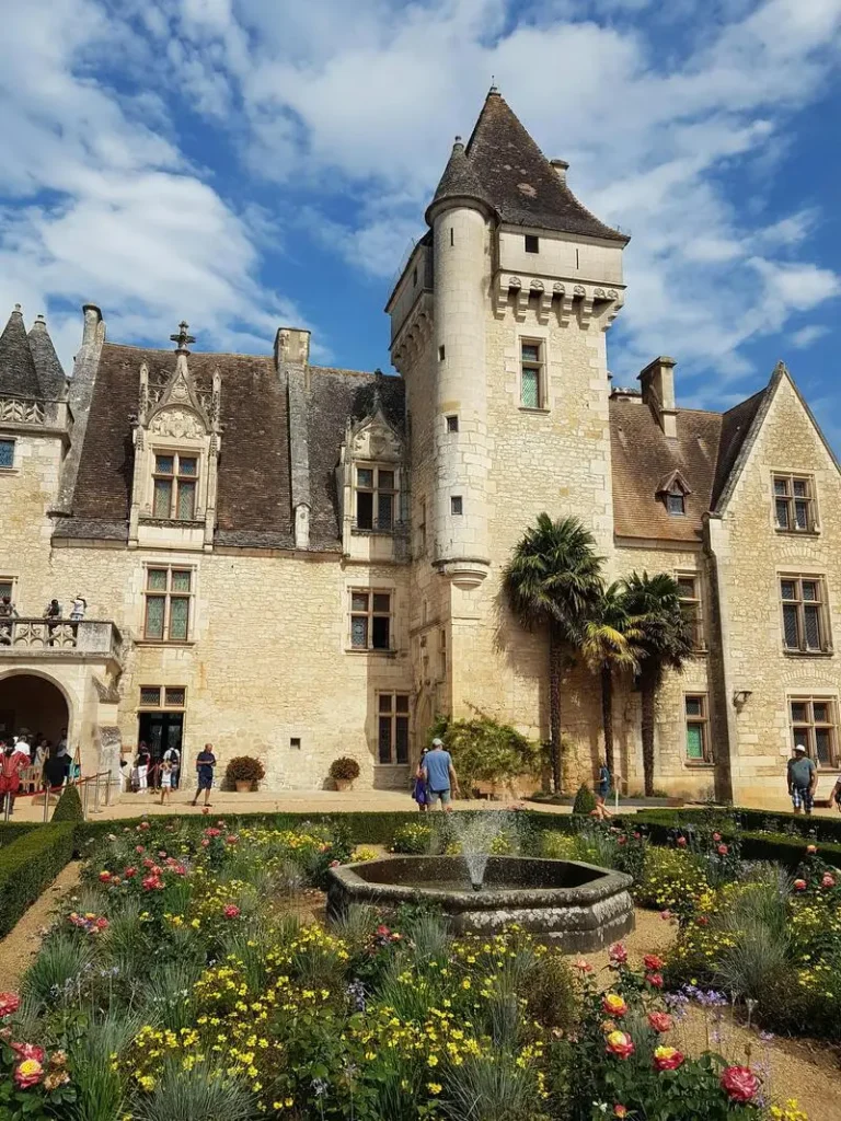 Front façade of Château des Milandes with its elegant garden in the foreground