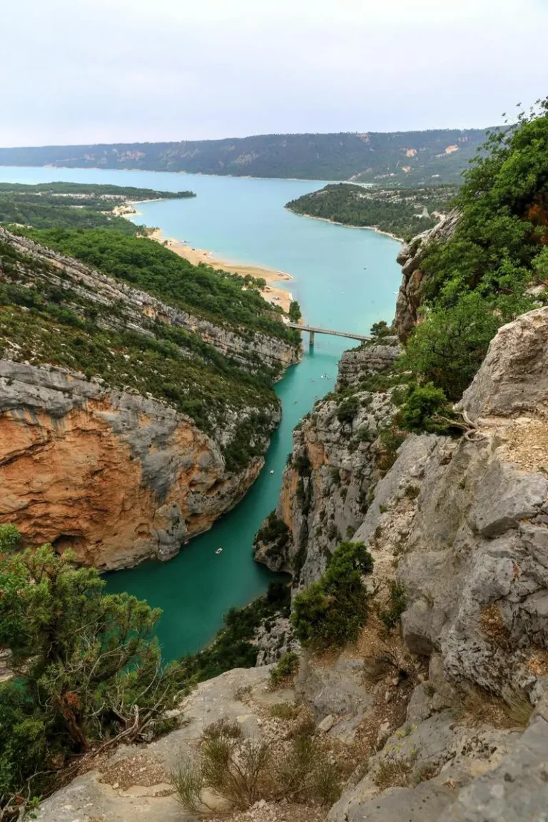 View of the Verdon River flowing between cliffs, widening in the distance