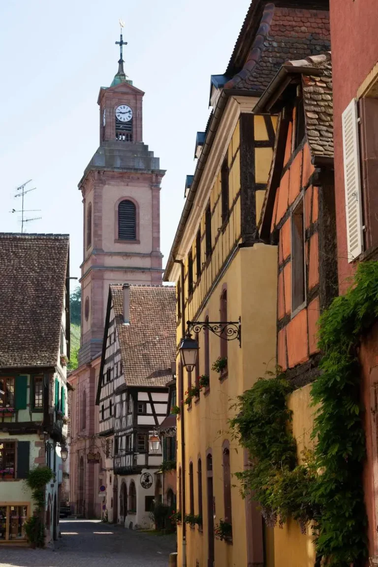 Colorful half-timbered houses lining a charming street in Riquewihr, Alsace